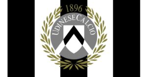 Logo dell’Udinese Calcio: scudo grigio e nero con all’interno una 'U' stilizzata bianca, circondato da una corona d’alloro dorata e scritta 'Udinese Calcio 1896' in alto.